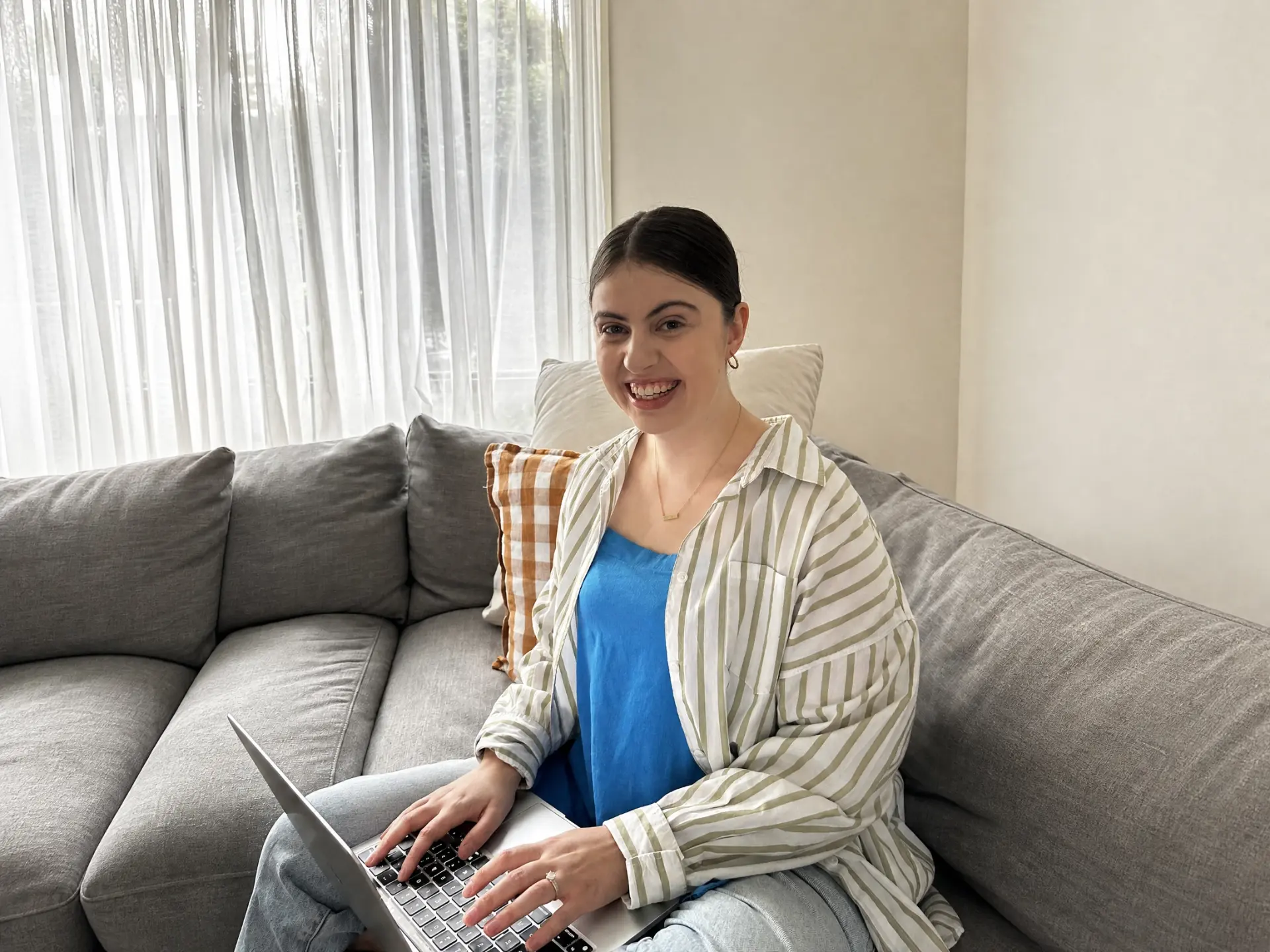 Sarah on the couch with her laptop, mid-build